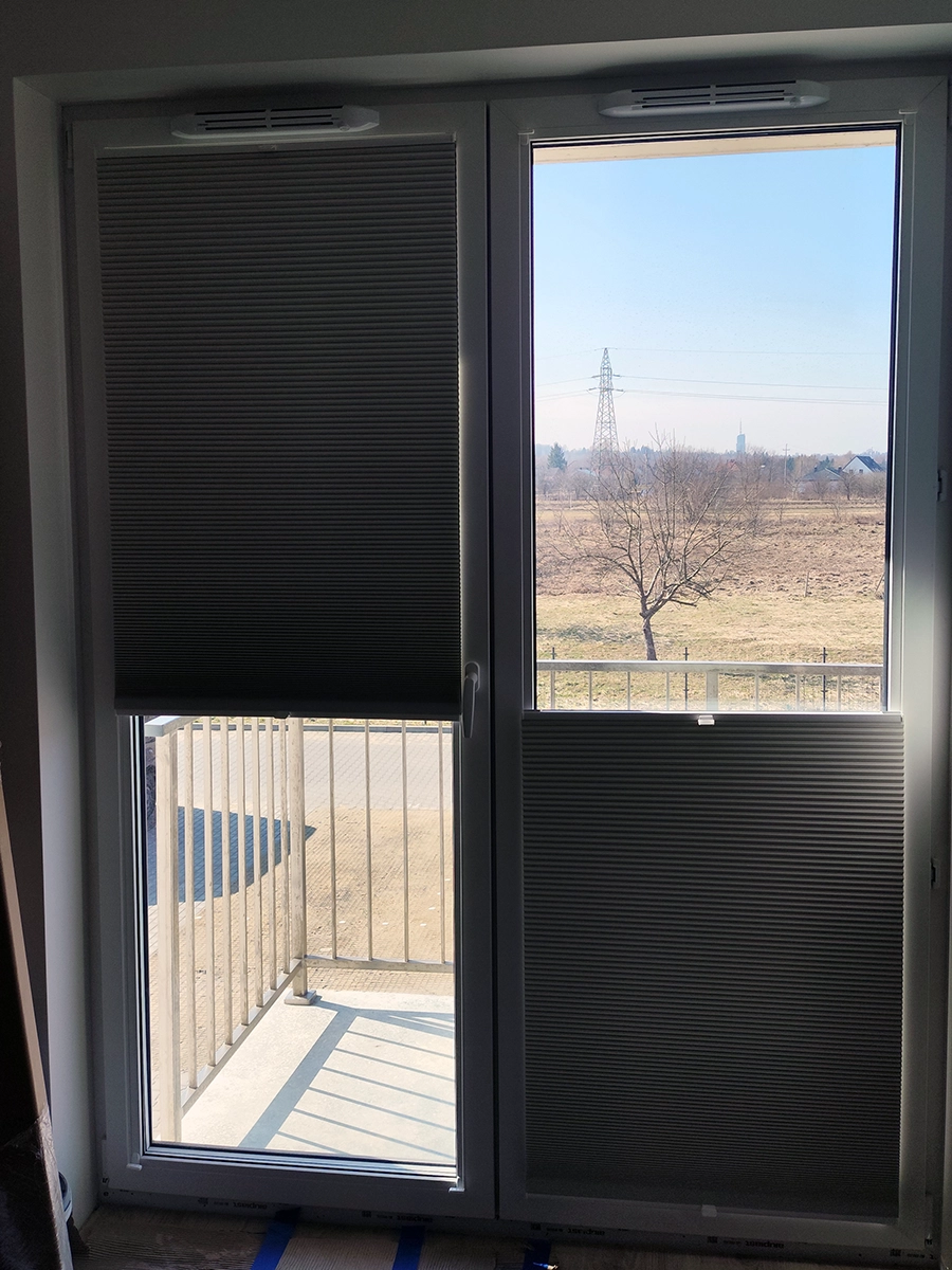 Plisy plaster miodu w oknie balkonowym – nowoczesna plisa bez otworów po sznurkach